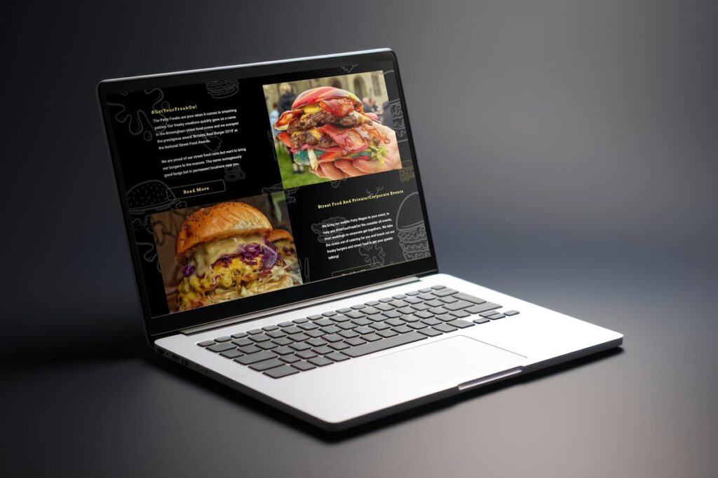 Mockup of a burger-focused website displayed on a laptop screen, featuring bold images of stacked, loaded burgers with details on street food services and private events. The text highlights the brand's commitment to quality, with slogans like #GetYourFreakOn promoting unique burger creations from Patty Freaks.