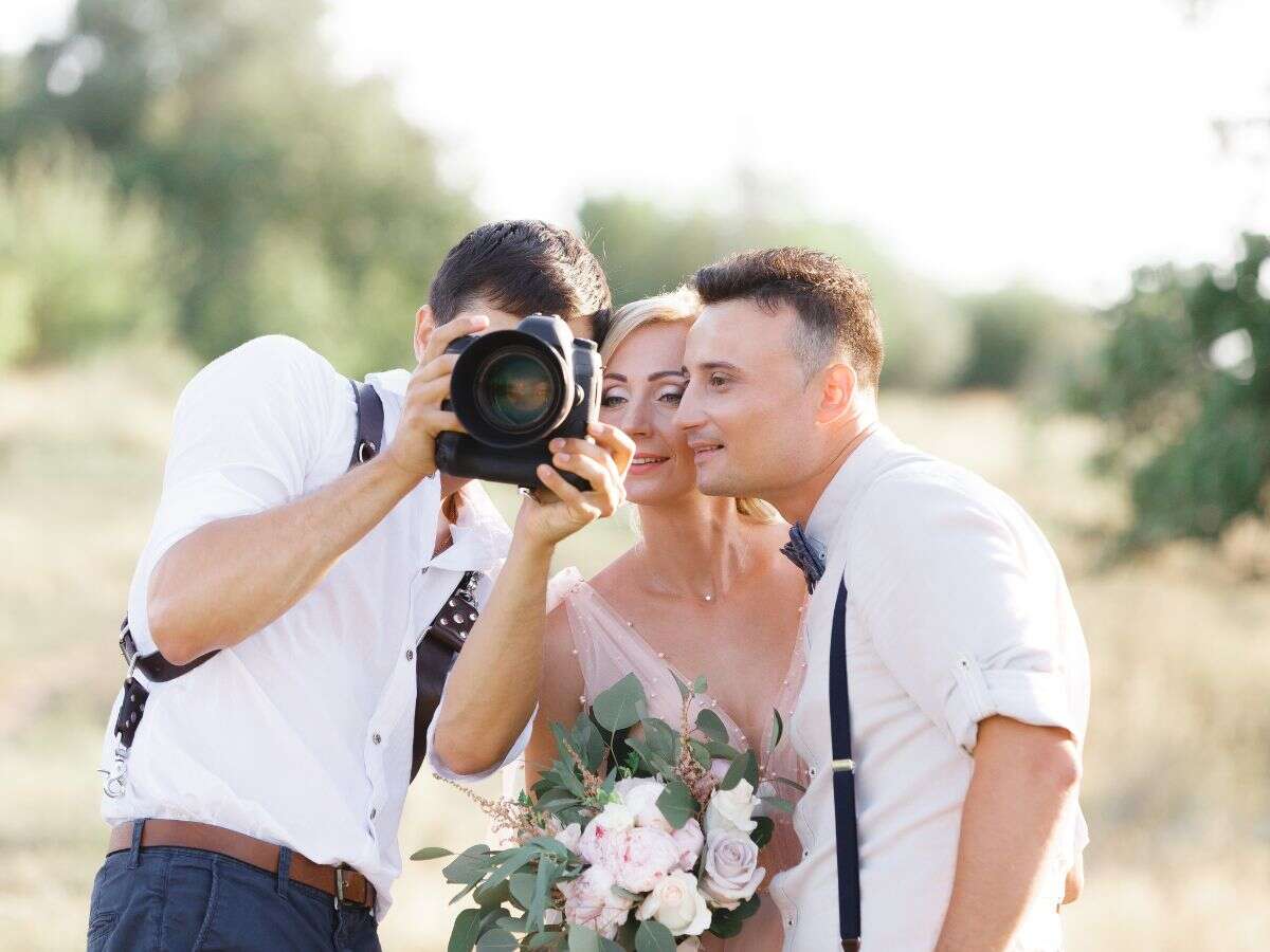 Wedding Photographer shows images to bride and groom