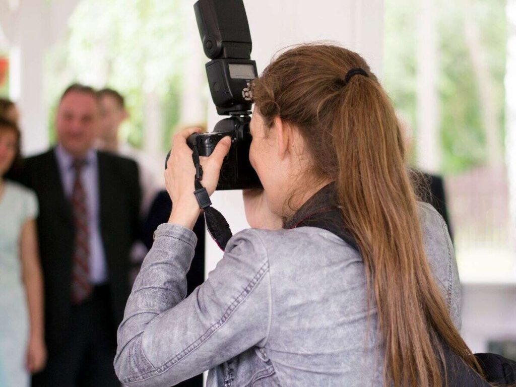 Back of a person photographing a bride and groom