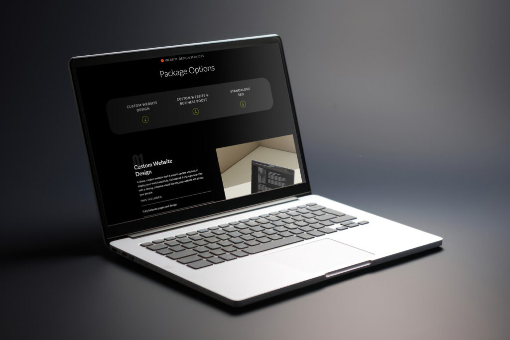 Laptop displaying a custom website & SEO services page with package options.