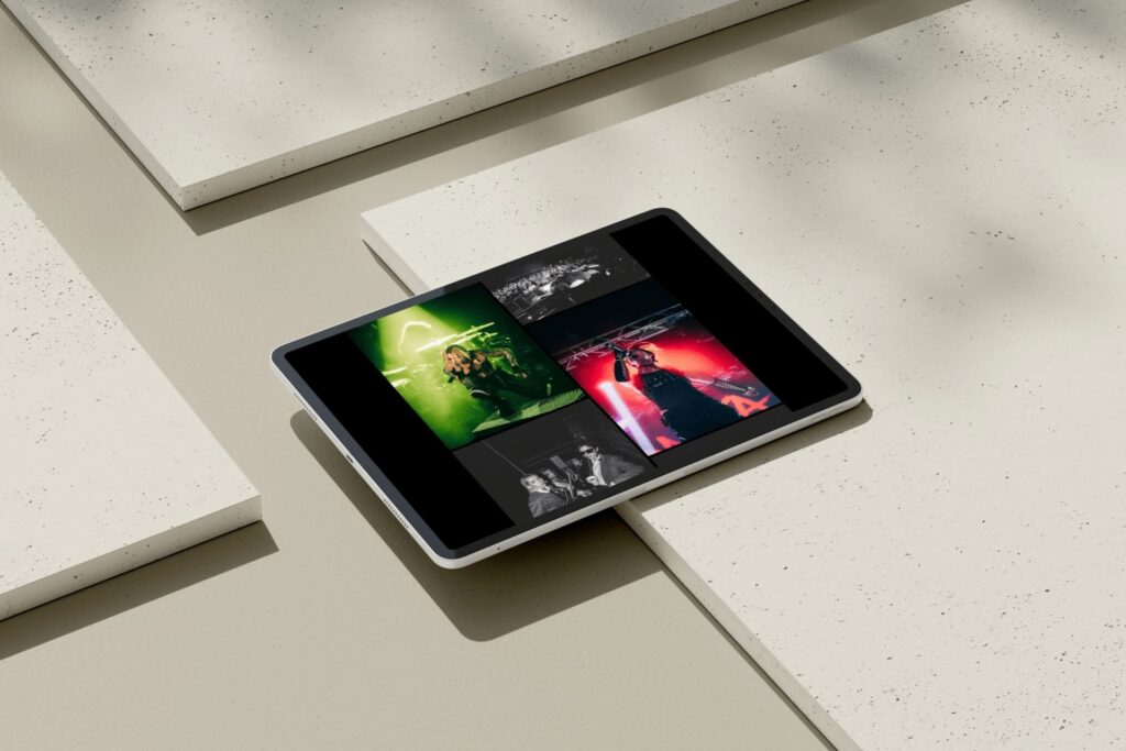 Tablet displaying a photographer's portfolio website featuring vibrant concert and event photography in a clean, modern layout.